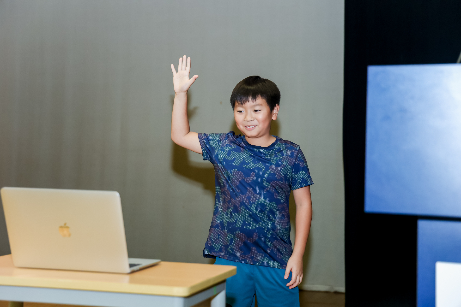 A young Bytewise student raising their hand in a Hong Kong AI class